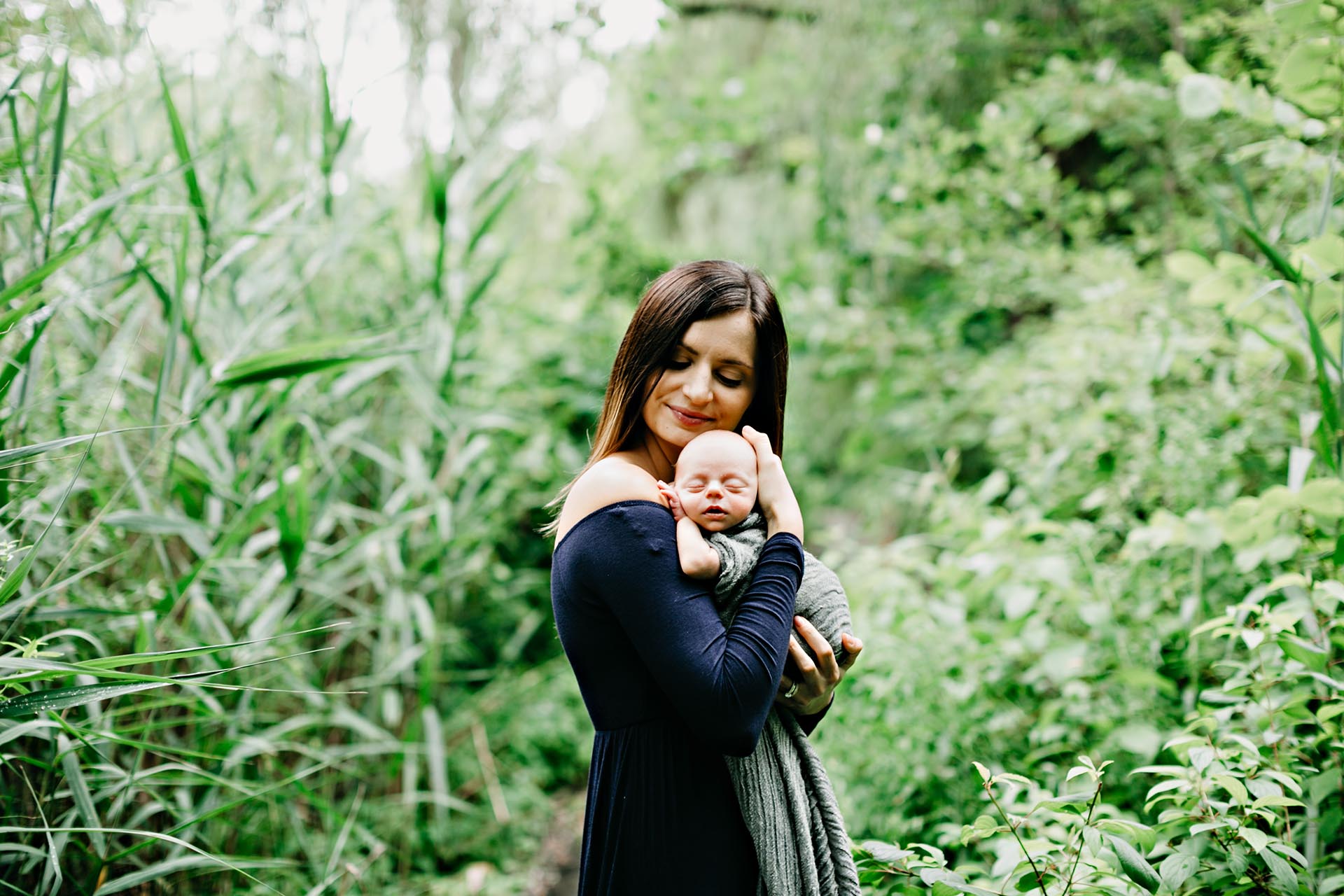 woman in forest with newborn