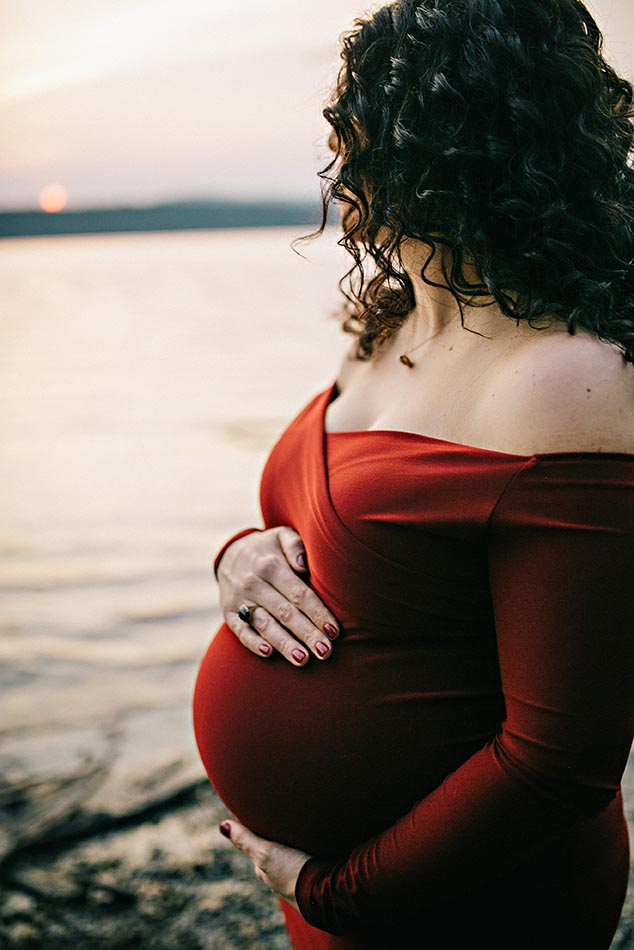 pregnant woman holding stomach
