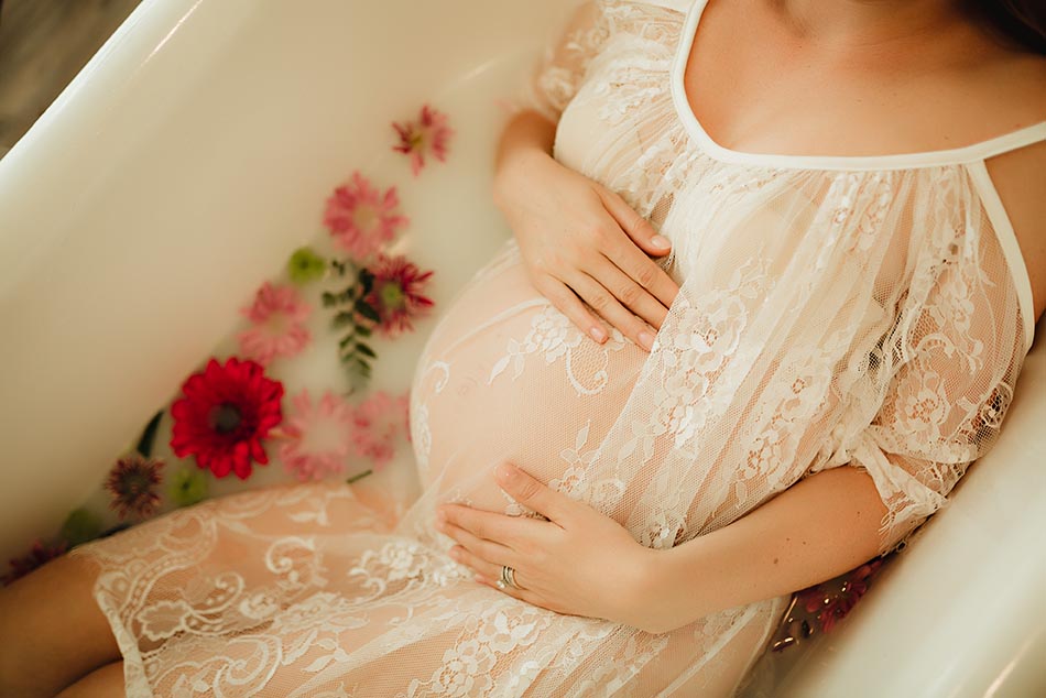 pregnant woman in gown in bathtub