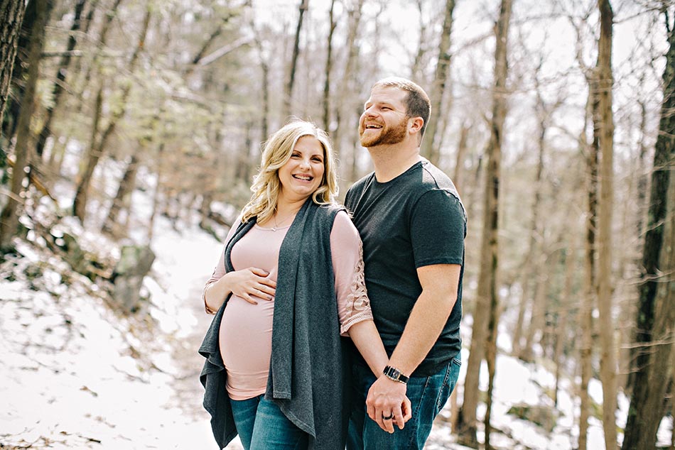 pregnant couple in winter woods