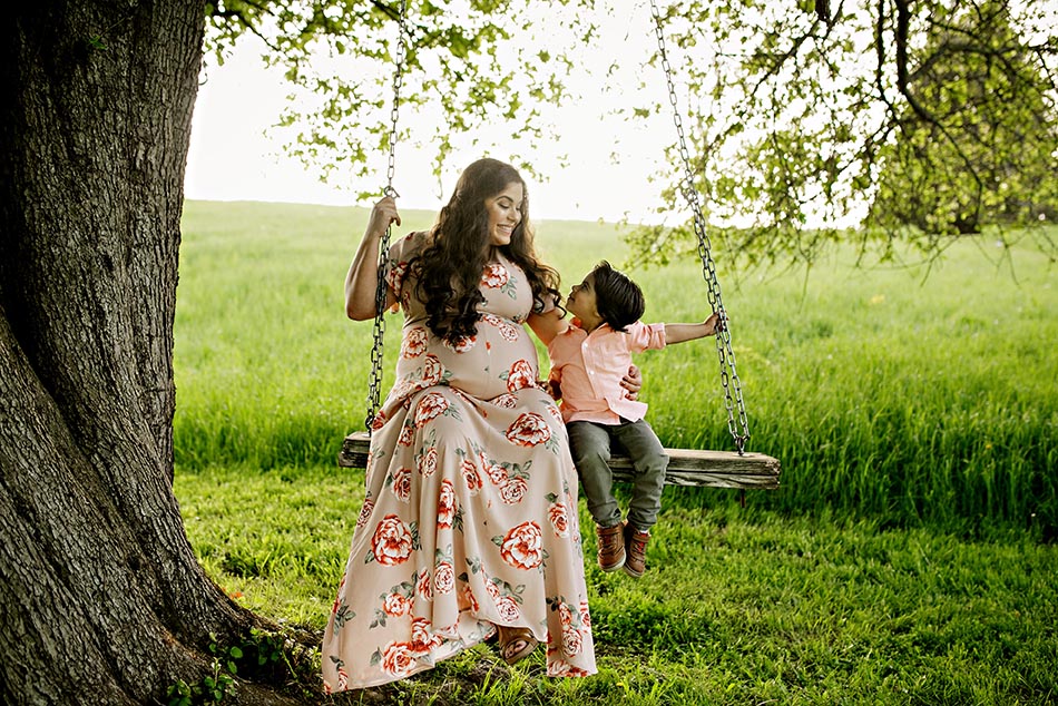 pregnant mom with child on swing